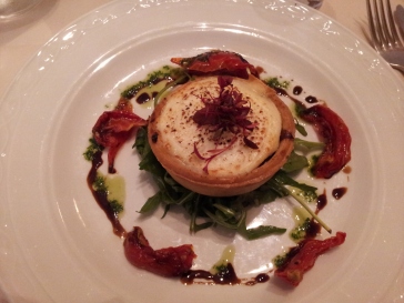 Carmelized onion and goat cheese tart on a bed of rocket. Almost too pretty to eat. Tiny, but richly delicious.
