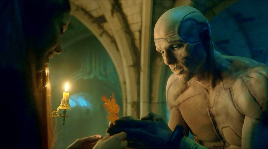 In the basement, the Creature hands a dried leaf to Elizabeth, who has come down to see him. 