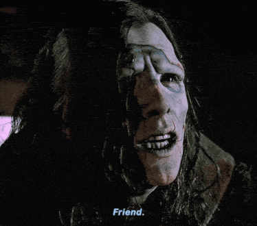 Adam, a man with a terribly scarred face and long hair, is in distress because his friend has just died. He says "Friend," and looks down in sorrow. 